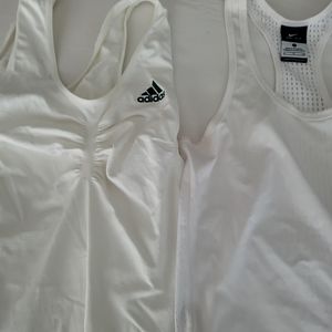 Two white size small athletic tank tops. One Adidas and one Nike.